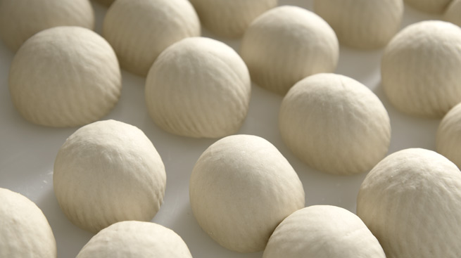 IT ROUNDS THE DOUGH PORTIONS AS IF HANDMADE